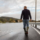 Man walking on flooded road in Kristiansted, Norway.