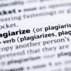 Plagiarism definition, close up view dictionary